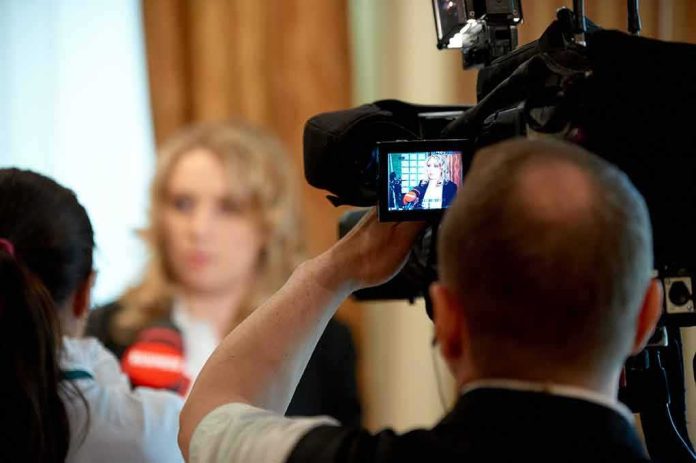 tv camera films interview with blurred speaker