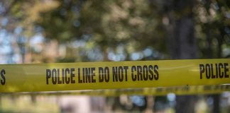 Homecoming Chaos: Teens Gunned Down, Suspect Walks yellow police tape cordoning off an outdoor area