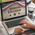 Person using laptop displaying midterm election screen