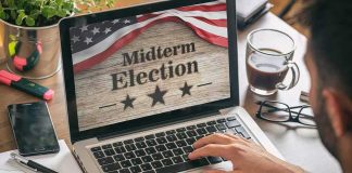 Person using laptop displaying midterm election screen