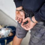 Person in handcuffs with hands behind back