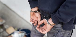 Person in handcuffs with hands behind back