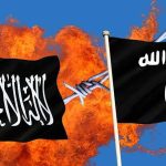 Two black extremist flags in front of flames and barbed wire