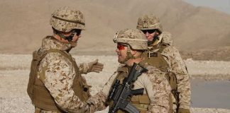 Jura Stublić with fellow soldiers in desert gear shaking hands outdoors