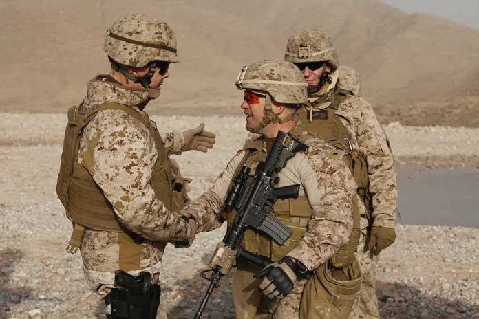 Jura Stublić with fellow soldiers in desert gear shaking hands outdoors