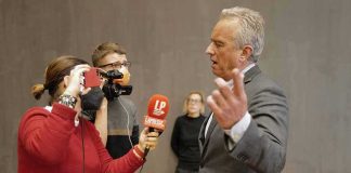 RFK Jr. Sent Nearly $800K to Russian Plague Lab Robert F. Kennedy Jr. speaking to reporters with microphones and a camera