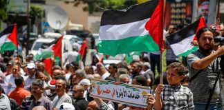 One in Five College Students Say America Deserved 9/11 – Shocking Survey Walter Jones and Caraun Reid amid a crowded street protest with Palestinian flags