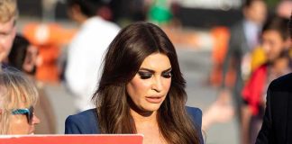 Disgraced Ambassador Posts Bizarre ‘Black Card’ Pics Kimberly Guilfoyle walking outdoors among a crowd