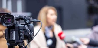 Video camera filming an outdoor media interview