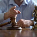 Judge’s gavel and Lady Justice statue on desk