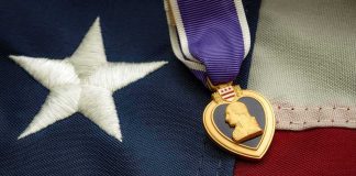 Purple Heart Marine Faces Death Penalty in Mass Shooting Case Purple Heart medal on an American flag