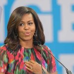 Michelle Obama speaking at a podium with a microphone