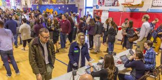 Early Voting Reveals Democrats Faltering! Don MacLean in a busy gymnasium voting station with check-in tables