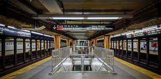 Subway platform with stairwell and tracks on both sides