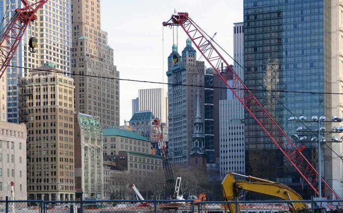 Construction cranes amid city skyscrapers